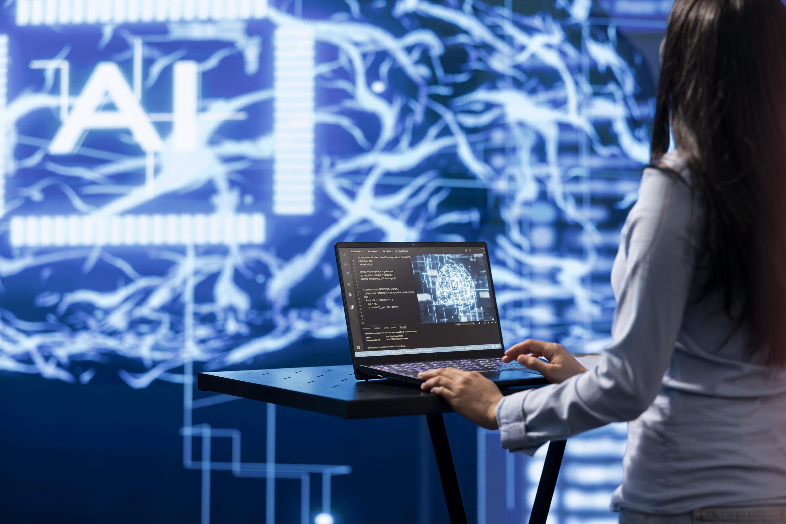 AI computer scientist using laptop for business data analysis in high tech workplace. Close up shot of woman working on notebook to automatize tasks using artificial intelligence